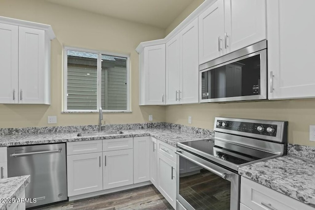 1910 E Rainbow Trl, Payson, AZ 85541 - kitchen with white cabinetry, appliances with stainless steel finishes, light stone counters, and a sink
