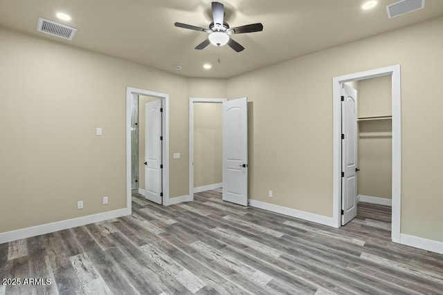 1910 E Rainbow Trl, Payson, AZ 85541 - unfurnished bedroom featuring a spacious closet, wood finished floors, and visible vents