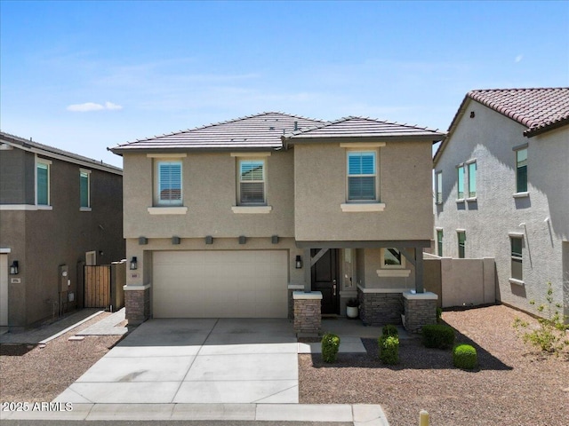 880 S 150th Dr, Goodyear, AZ 85338 - view of front of home with stucco siding, driveway, an attached garage, and a tiled roof