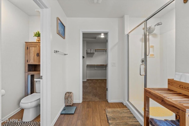 880 S 150th Dr, Goodyear, AZ 85338 - full bathroom featuring a stall shower, wood finished floors, and a spacious closet
