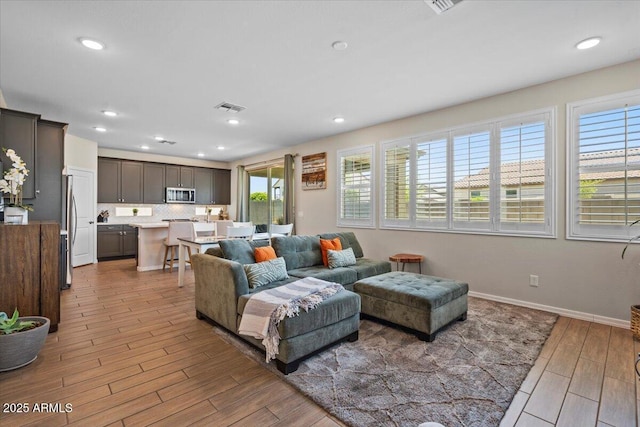 880 S 150th Dr, Goodyear, AZ 85338 - living room featuring wood finished floors and recessed lighting