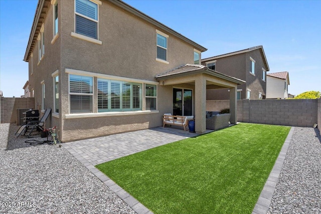 880 S 150th Dr, Goodyear, AZ 85338 - back of property featuring stucco siding, a fenced backyard, and a patio area