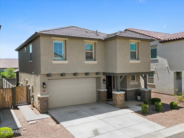 880 S 150th Dr, Goodyear, AZ 85338 - view of front of house featuring stone siding, a garage, stucco siding, and driveway