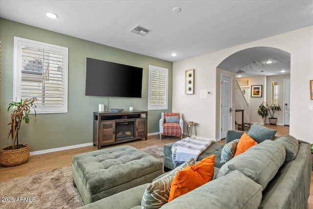 880 S 150th Dr, Goodyear, AZ 85338 - living area with arched walkways, wood finished floors, stairway, and recessed lighting