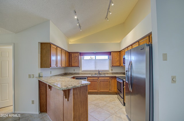 kitchen featuring lofted ceiling, sink, a textured ceiling, kitchen peninsula, and stainless steel appliances