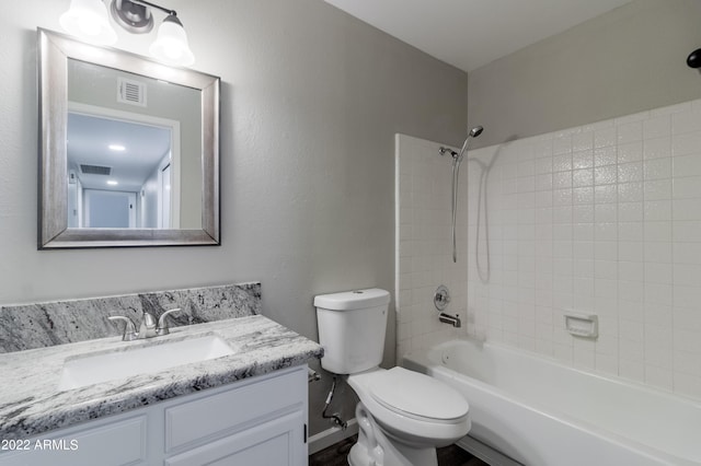 bathroom featuring vanity, toilet, bathtub / shower combination, and visible vents