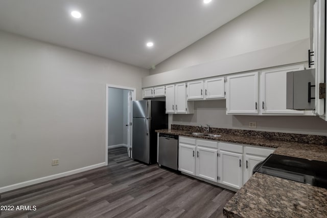 kitchen with white cabinetry, lofted ceiling, appliances with stainless steel finishes, and a sink