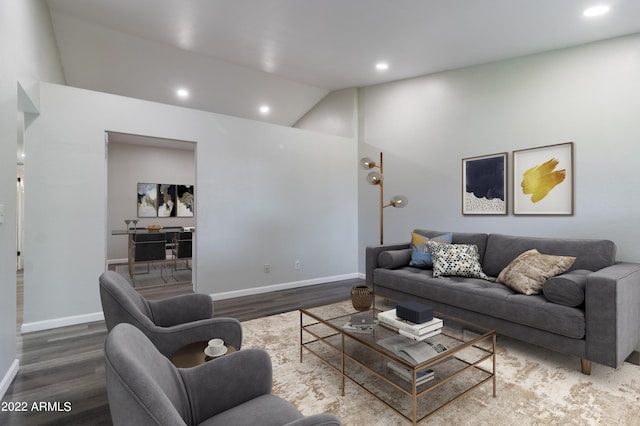 living area with recessed lighting, baseboards, lofted ceiling, and wood finished floors