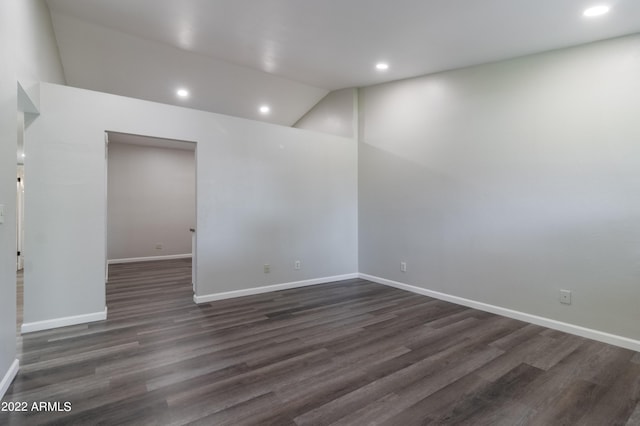 spare room with recessed lighting, baseboards, lofted ceiling, and dark wood-style flooring