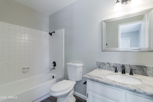 bathroom featuring baseboards, shower / bathtub combination, toilet, and vanity