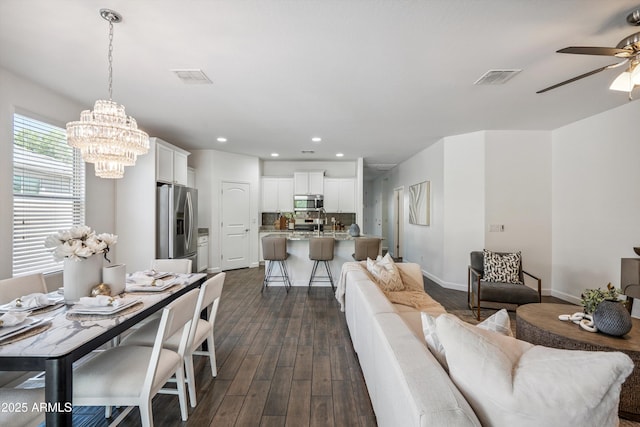 13529 W Remuda Dr, Peoria, AZ 85383 - living room featuring a chandelier, dark wood finished floors, ceiling fan, and recessed lighting