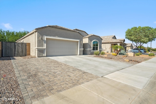 13529 W Remuda Dr, Peoria, AZ 85383 - ranch-style home with driveway, an attached garage, stucco siding, and a gate