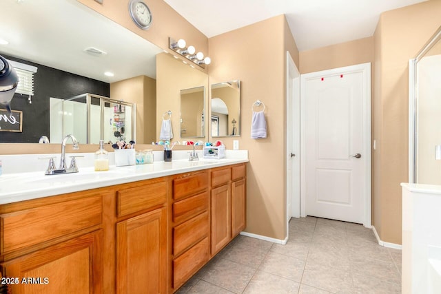 bathroom with tile patterned flooring, vanity, and an enclosed shower