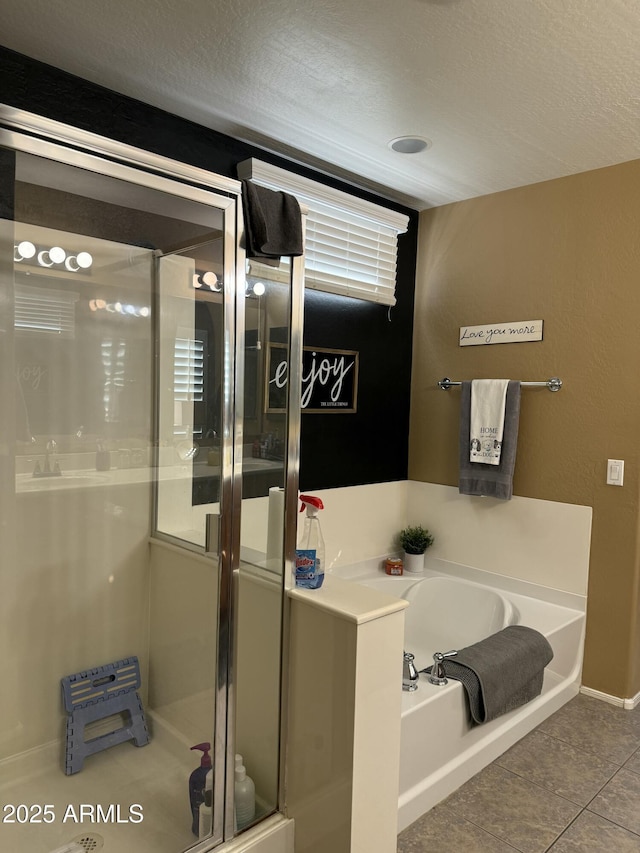 bathroom featuring tile patterned floors and shower with separate bathtub