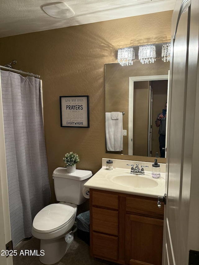 bathroom with tile patterned flooring, vanity, and toilet