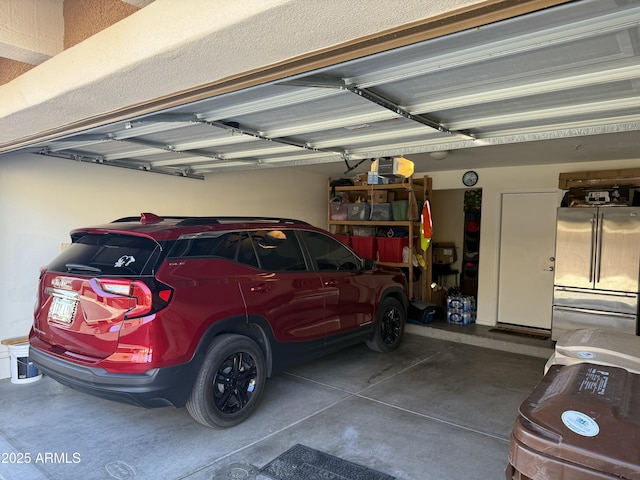 garage featuring stainless steel fridge