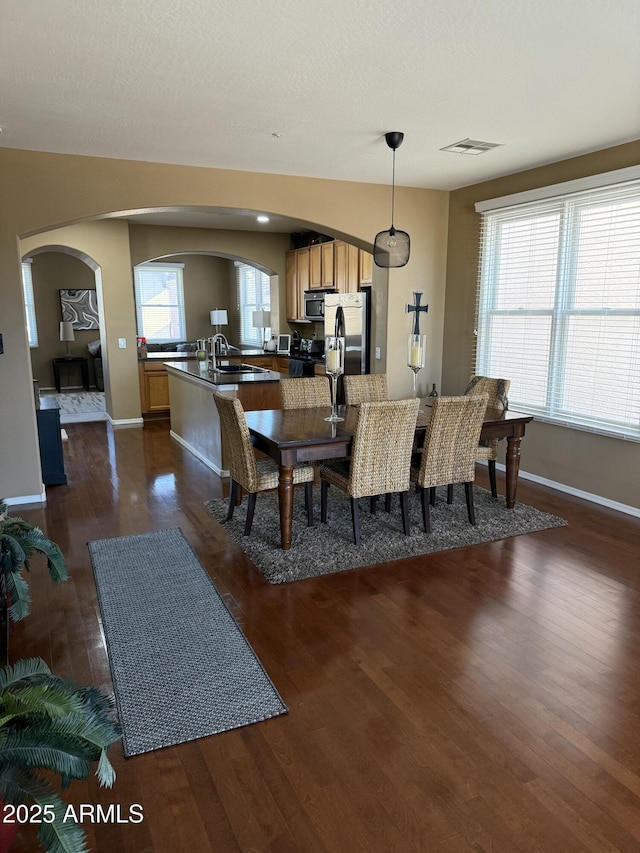 dining room featuring dark hardwood / wood-style flooring and sink