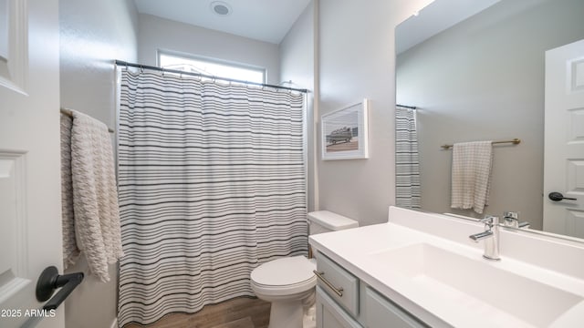 full bath featuring a shower with curtain, vanity, toilet, and wood finished floors