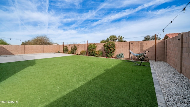 view of yard featuring a patio area and a fenced backyard