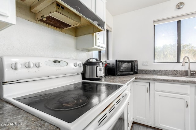 kitchen featuring white cabinetry, sink, and electric stove