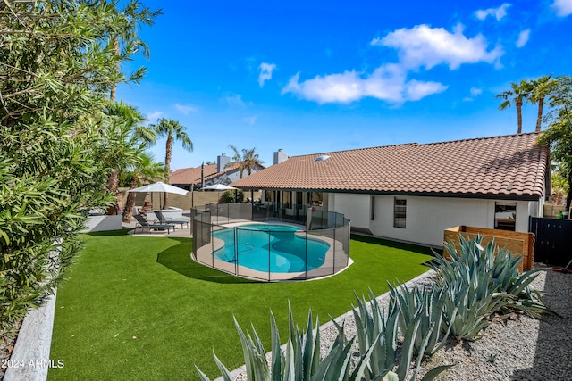 view of swimming pool featuring a yard and a patio area