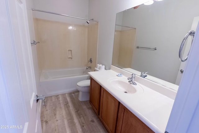 bathroom with vanity, bathing tub / shower combination, toilet, and wood finished floors