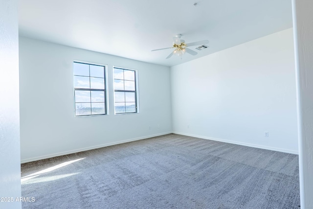 unfurnished room with visible vents, baseboards, a ceiling fan, and carpet floors