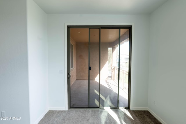 unfurnished bedroom with access to outside, baseboards, and carpet floors