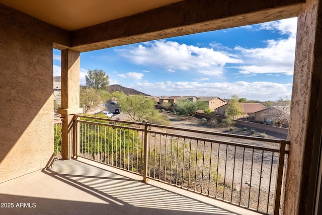 balcony featuring a residential view and a mountain view