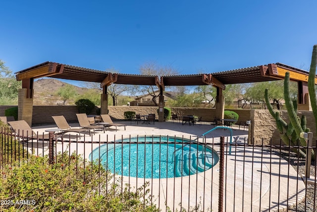 view of swimming pool with a patio area, fence, and a pergola