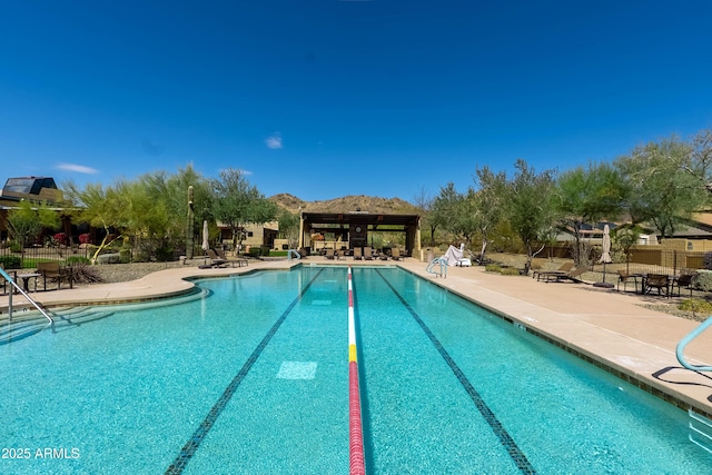 pool featuring a patio area, a gazebo, and fence