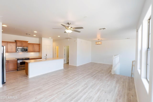 kitchen with visible vents, appliances with stainless steel finishes, light countertops, and light wood-type flooring