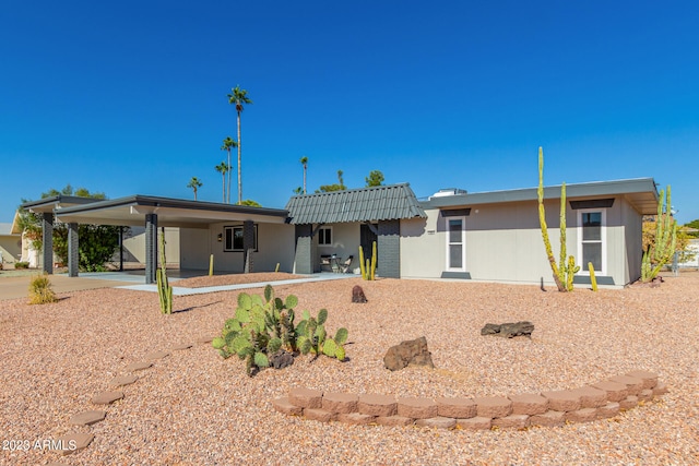 back of property featuring a carport