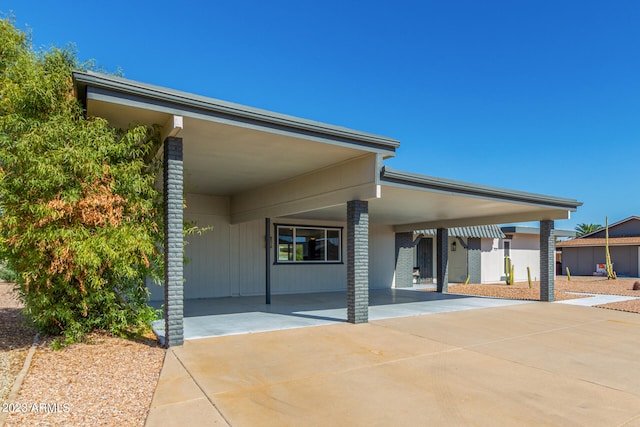 rear view of property featuring a carport