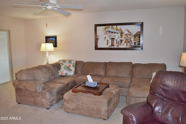 carpeted living room featuring ceiling fan and a textured ceiling