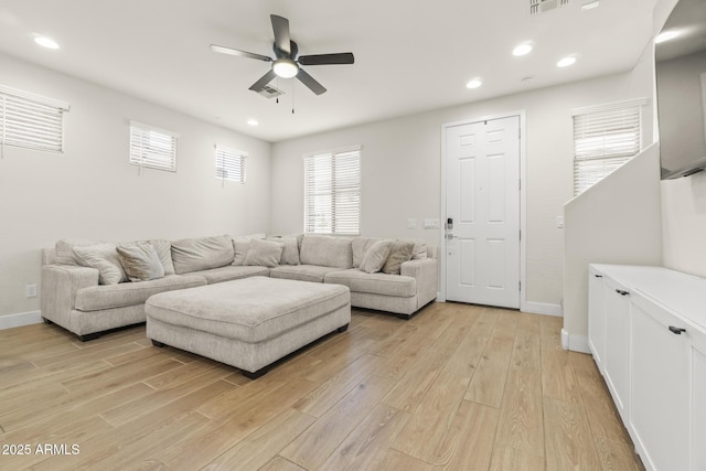 living area with ceiling fan, light wood-style flooring, plenty of natural light, and recessed lighting