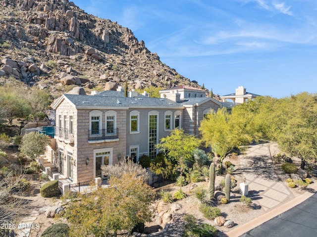 back of property featuring a mountain view