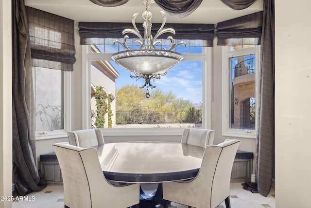 dining area with a chandelier and a wealth of natural light