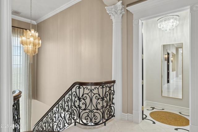 corridor with an inviting chandelier, ornamental molding, tile patterned flooring, and decorative columns