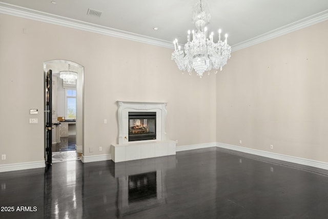 unfurnished living room featuring a premium fireplace, dark wood-type flooring, a notable chandelier, and crown molding