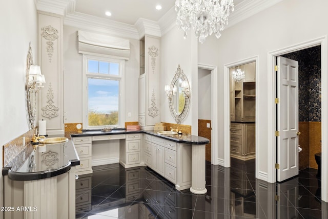 bathroom featuring crown molding, vanity, and a chandelier