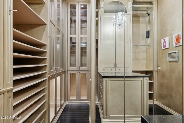 spacious closet with a notable chandelier