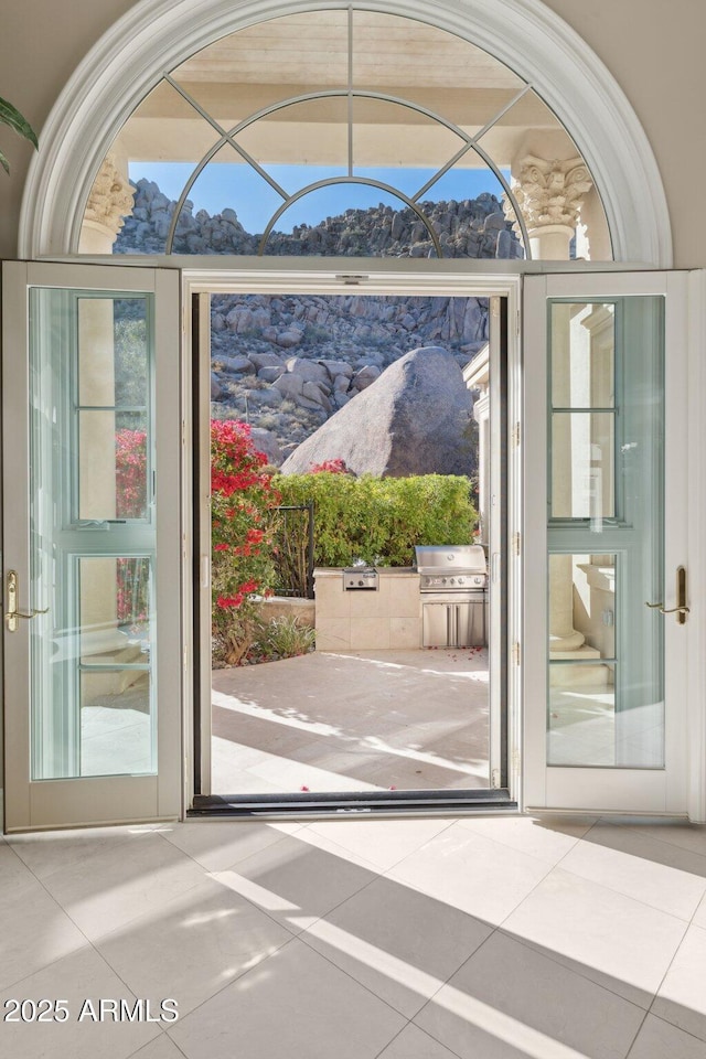 doorway to outside with tile patterned floors