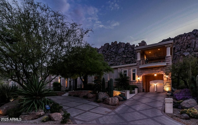 view of front of home featuring a garage and a balcony