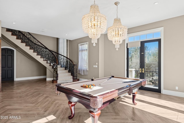 game room featuring parquet floors, billiards, french doors, and a chandelier