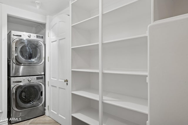 clothes washing area with stacked washer and dryer