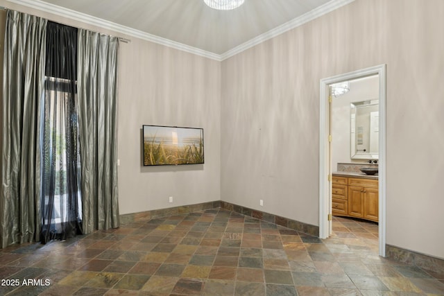 empty room featuring ornamental molding and sink