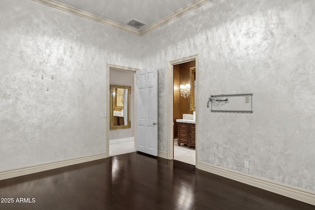 spare room with crown molding and dark hardwood / wood-style flooring