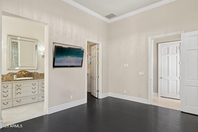 unfurnished bedroom featuring ornamental molding, connected bathroom, sink, and light wood-type flooring