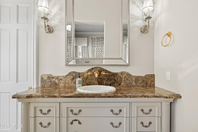 bathroom featuring crown molding and vanity